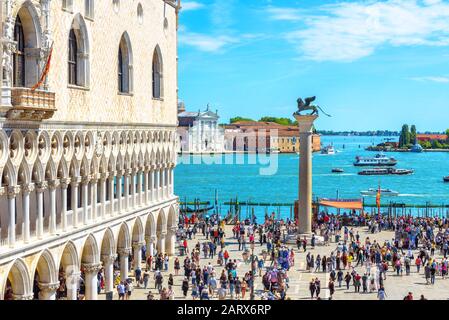 Venice, Italy - May 21, 2017: People visit the San Marco embankment in Venice. Doge`s Palace on left. This place is top tourist attraction of Venice. Stock Photo